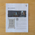 A printed educational worksheet titled 'BASIC 1-D KINEMATICS' laid flat on a light wood surface. The page includes a small color illustration, a scroll graphic with kinematic equations, and blocks of text explaining motion.