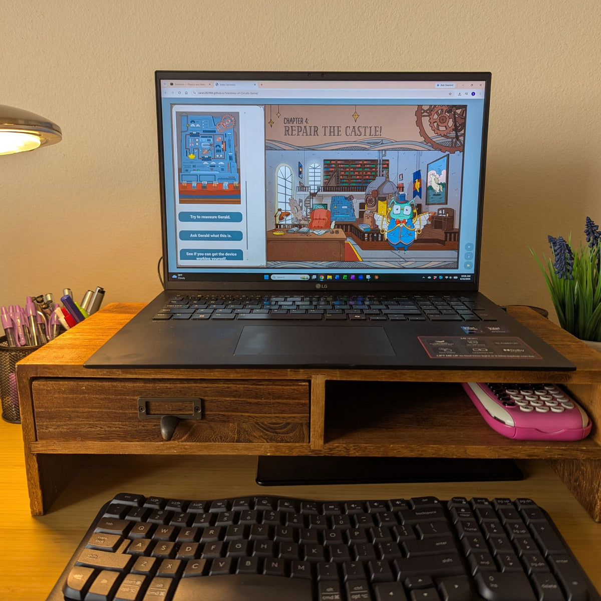 A wooden desktop monitor stand holding an open laptop on a desk. On the screen there is an illustration of an electrical control panel. The text reads 'Chapter 4: Repair the castle!'