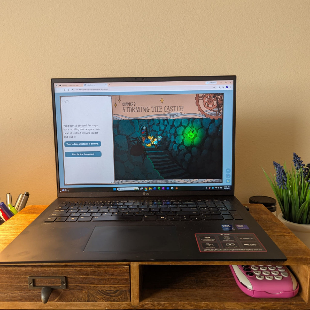 A black laptop sits on a wooden desk stand on a beige desk, displaying a video game or website on its screen. The game has a cute illustration of a dungeon, a spider, and a pickle lamp. The text reads 'Chapter 7: storming the castle!'