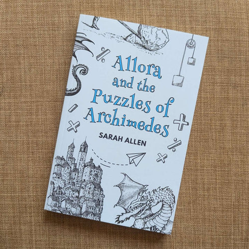the paperback of Allora sitting on fabric