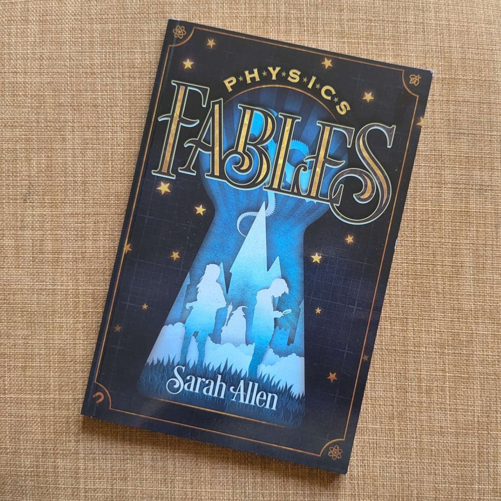 the paperback of Physics Fables sitting on  fabric
