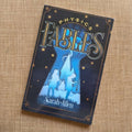 the paperback of Physics Fables sitting on  fabric