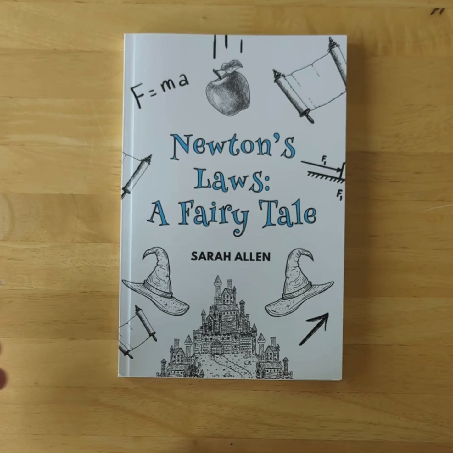 a video of hands flipping through Newton's Laws: A Fairy Tale showing many colorful illustrations